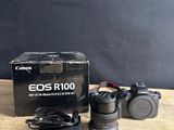 Appareil photo reflex numérique Canon EOS R100 avec objectif et chargeur