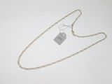 a close up of a gold chain with a tag on it