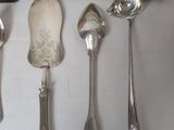 a lot of silver spoons and spoon spoons on a table