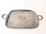 a silver tray with handles on a white surface