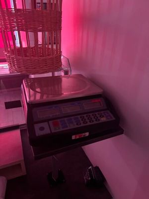 a scale with a basket on top of it in front of a window