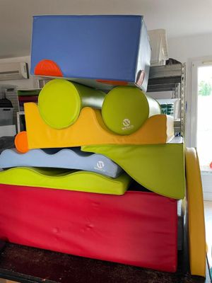 a large stack of colorful kitchen utensils stacked on top of each other