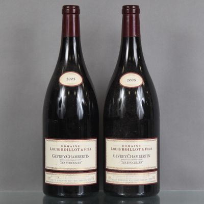 two bottles of wine sitting on top of a table next to each other
