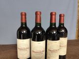 three bottles of wine sitting on top of a table next to each other