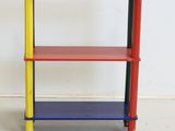 a multicolored shelf with three shelves on it