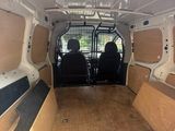 the back of a van with the doors open and the back of the van with the seats down