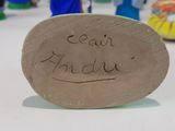 a clay plaque with the name of an angel on it