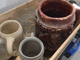 a wooden tray with cups and a vase on it