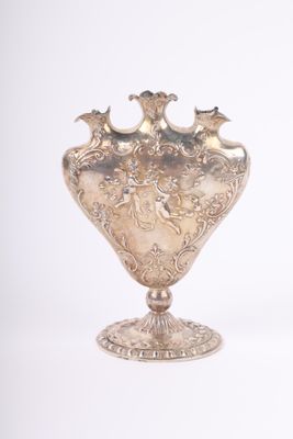 un vase en argent posé sur un socle, sur fond blanc