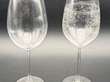 two wine glasses sitting next to each other on a table