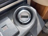 a digital clock on the dashboard of a car