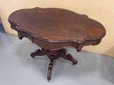a small table with a wooden top on a gray floor
