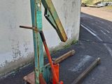 a rusted metal object sitting on the side of the road