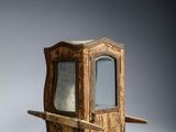 a small wooden cabinet with a mirror on it