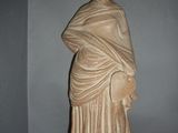a statue of a woman with a shaw around her neck