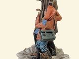 figurine of a man sitting on a bench with a child