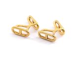 a pair of gold plated cufflinks on a white background