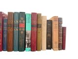 a row of old books on a shelf on a white background