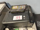 a printer sitting on top of a desk next to a printer