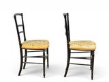 pair of black chairs with yellow upholstered seat and back