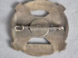 a metal buckle with a hole in the middle of it