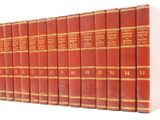 six red books lined up in rows on a white surface