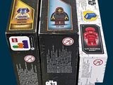 three boxes of lego star wars action figures on display