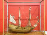a wooden model of a ship in a glass case