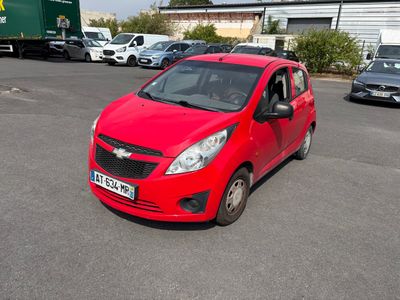 a red car that is parked in a parking lot