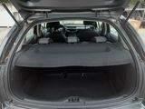 the back of a car with its trunk open in a parking lot