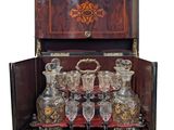 a wooden case with a lot of glassware in it