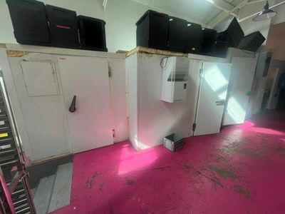 a pink floor in a room with a bunch of boxes on it