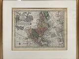 an old map of the world in a gold frame