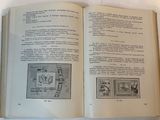 an open book on a table with stamps on it