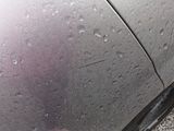 a close up of a car ' s tire with water droplets on it
