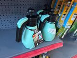 three teapots sitting on a shelf in a store