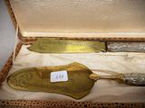 a box with two knives and a spoon in it