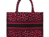 a red and black leopard print bag with a black stripe