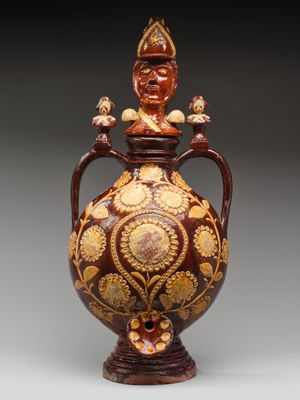 une image représentant un vase surmonté d'une statue