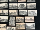 a lot of old black and white pictures on the table