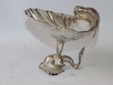 a silver plate with a bird on top of it