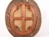 an old wooden circular window with a cross on it