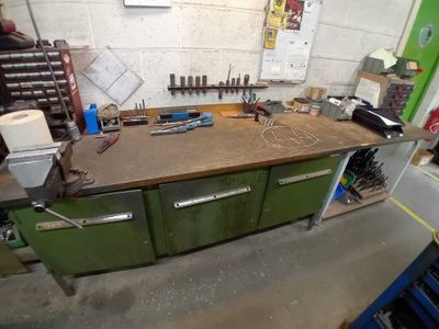 une photo d'un établi dans un garage avec des outils