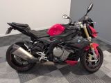 a black and red motorcycle parked on a checkered floor