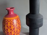 two vases sitting next to each other on a table