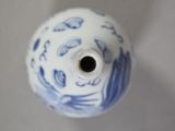 a blue and white vase with a bird design on it