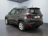 the back of a grey jeep compass parked inside of a building