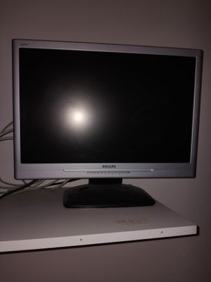 a computer monitor sitting on top of a white desk