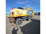 a picture of a large yellow truck parked in a parking lot
