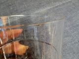 a glass of water and a bottle of liquor on a table